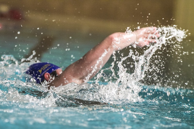 A man swimming in the swimming pool