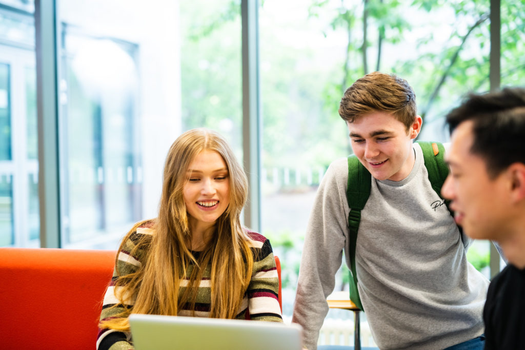 Students checking the careers service on laptop