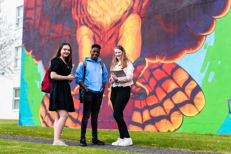 image of 3 student ambassadors at atu sligo mural